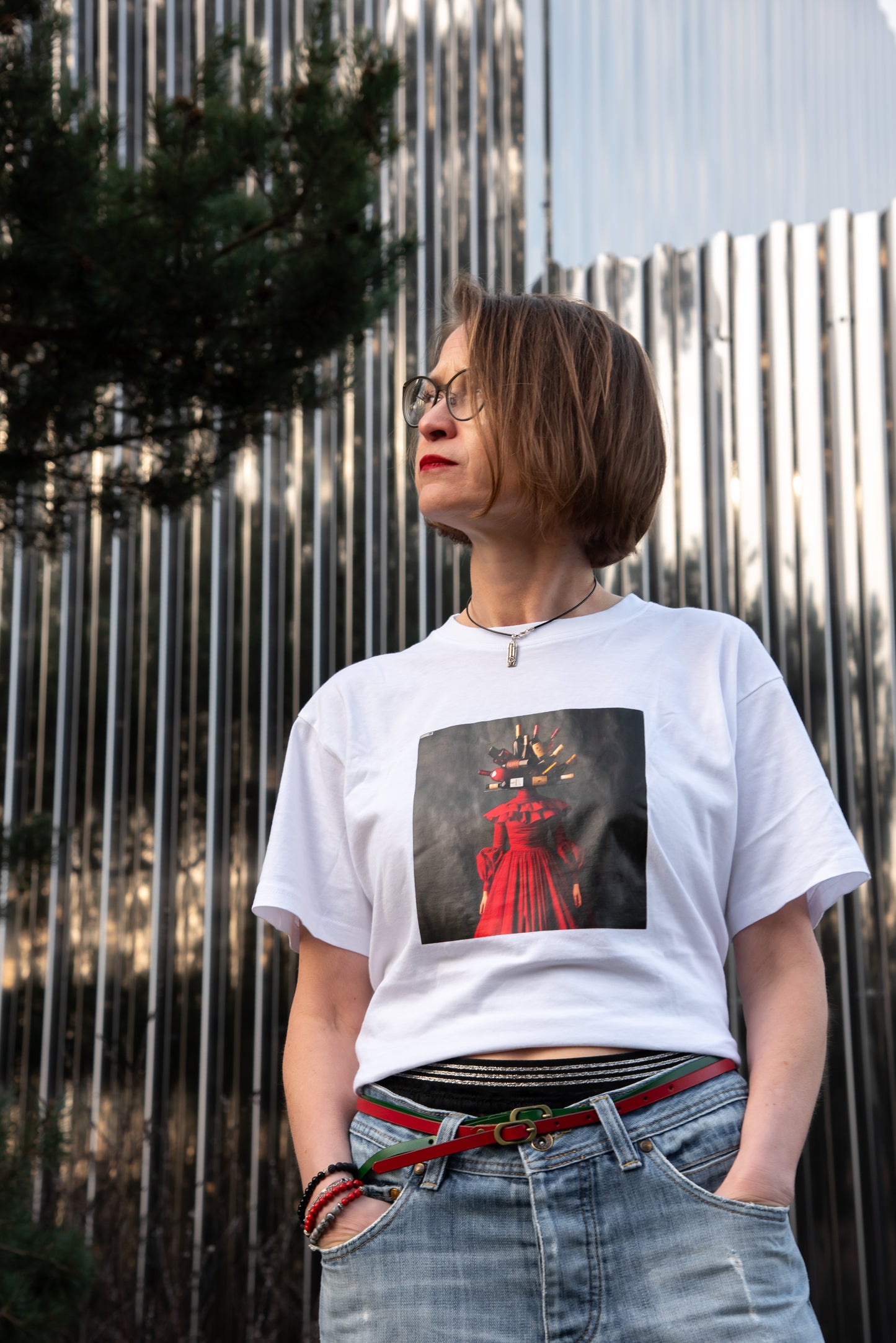 White unisex T-shirt with AI-generated wine couture print from M2ArtWear, styled with denim skirt, on a model in Zurich