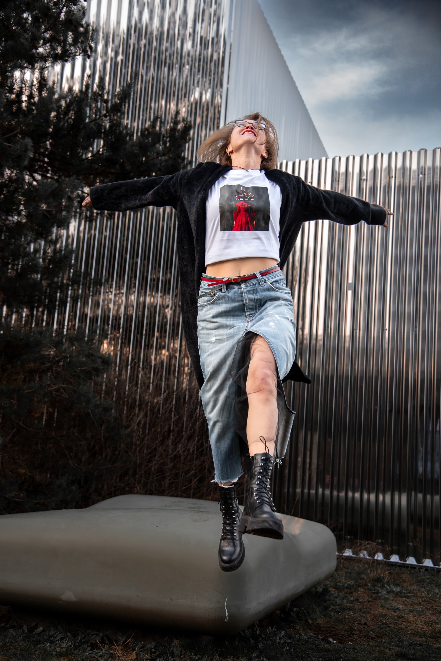 White unisex T-shirt with AI-generated wine couture print from M2ArtWear, styled with denim skirt, on a model in Zurich