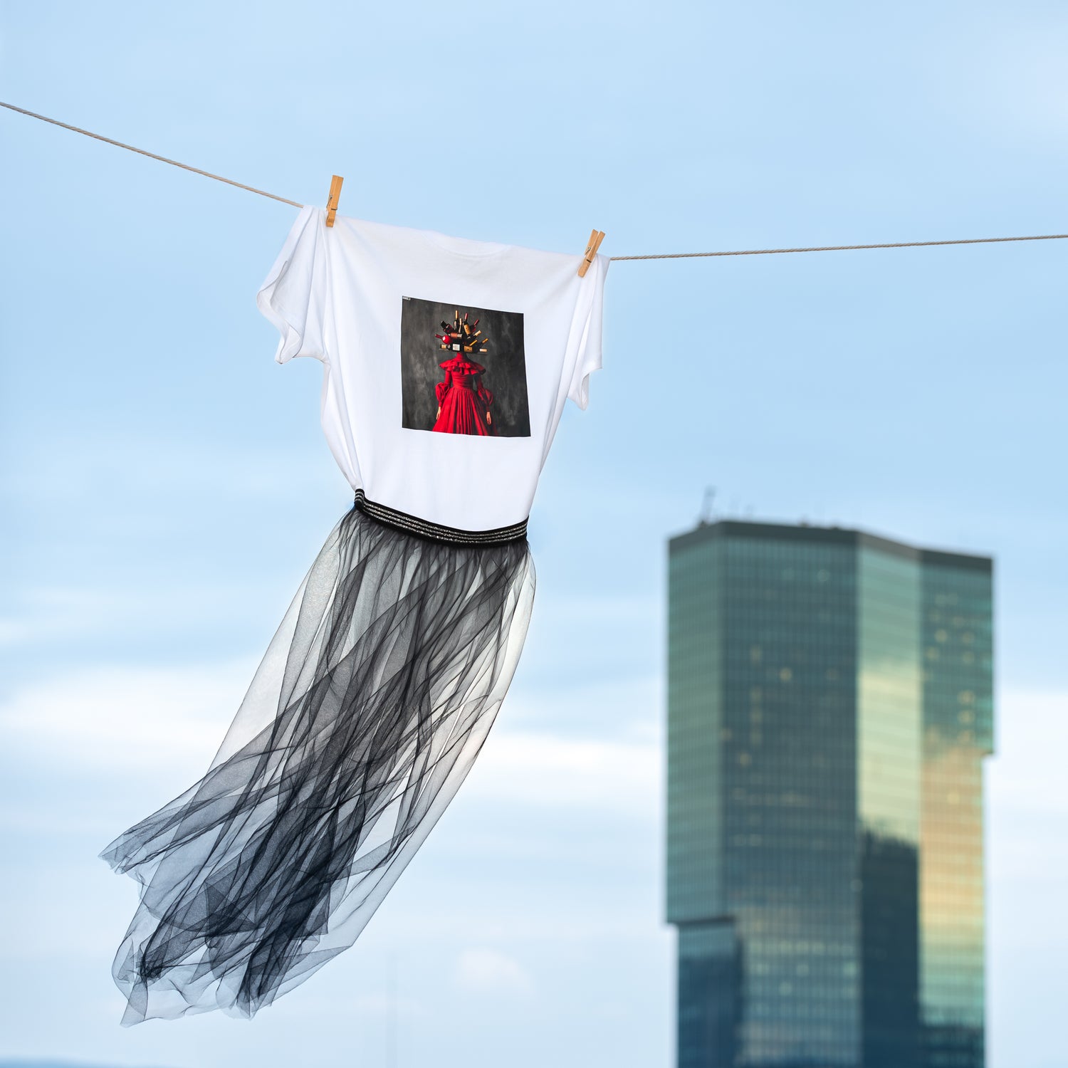 White unisex T-shirt with AI-generated wine couture print from M2ArtWear, styled with transparent skirt, gently blowing in the wind nest to Prime tower in Zurich